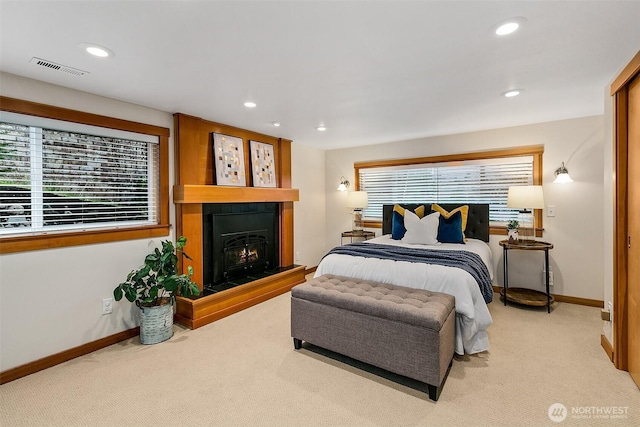 bedroom with visible vents, baseboards, a lit fireplace, carpet floors, and recessed lighting