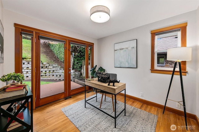 office featuring french doors, light wood finished floors, and baseboards