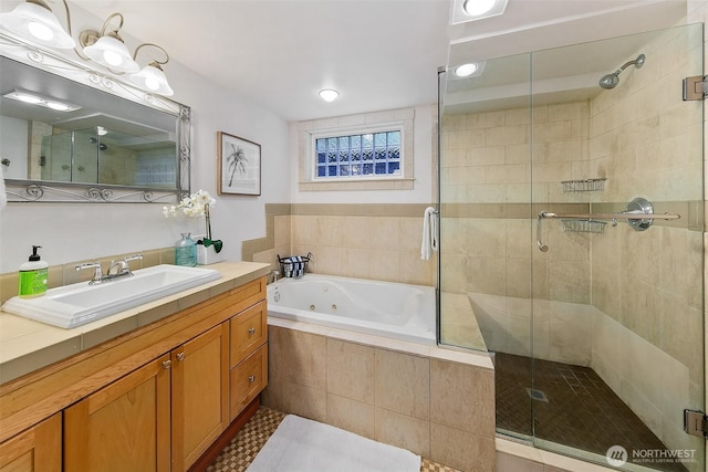 full bathroom with a shower stall, a tub with jets, and vanity