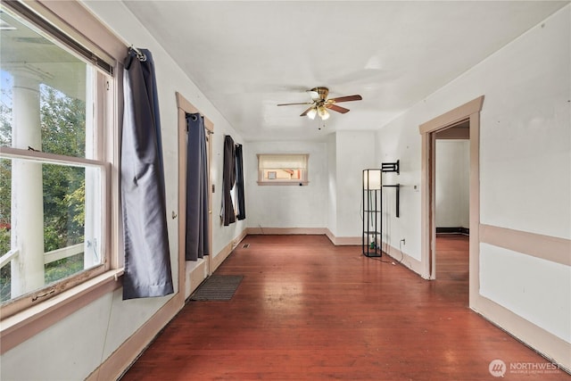 interior space with visible vents, a healthy amount of sunlight, baseboards, and wood finished floors