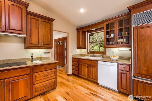 kitchen with dishwasher, black electric cooktop, paneled refrigerator, under cabinet range hood, and a sink