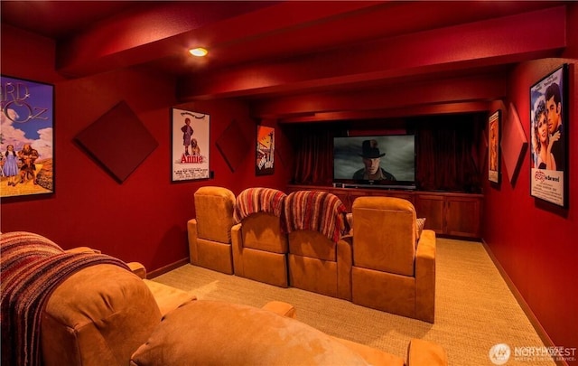 carpeted home theater with baseboards