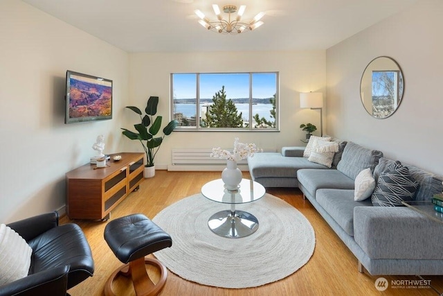 living area featuring a chandelier and wood finished floors