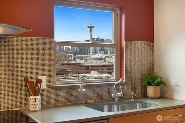 kitchen with a view of city, backsplash, and a sink