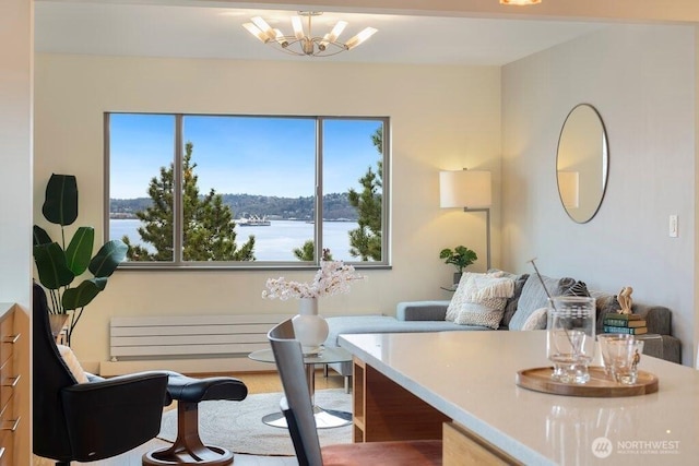 office featuring a water view and an inviting chandelier