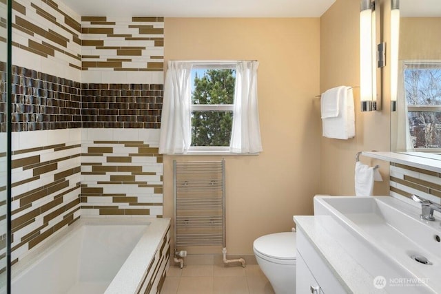 full bath with baseboards, vanity, toilet, and tile patterned floors