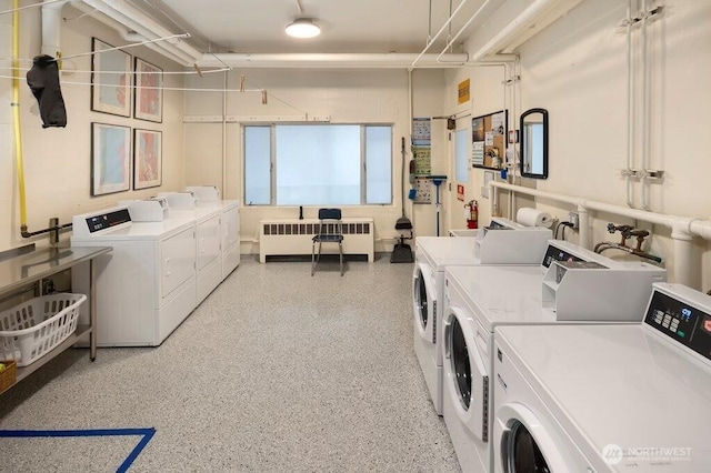 common laundry area featuring washing machine and dryer and radiator heating unit