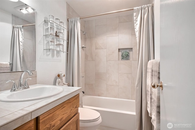 bathroom with shower / bath combo with shower curtain, toilet, and vanity