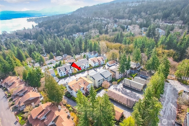 aerial view featuring a residential view and a wooded view