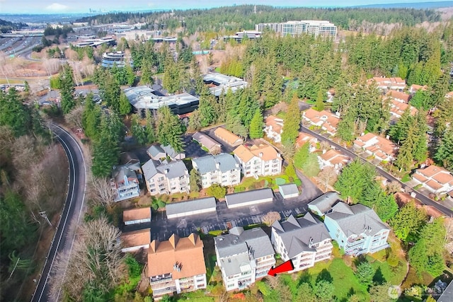 birds eye view of property with a view of trees and a residential view