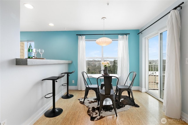 dining room featuring plenty of natural light, recessed lighting, and baseboards