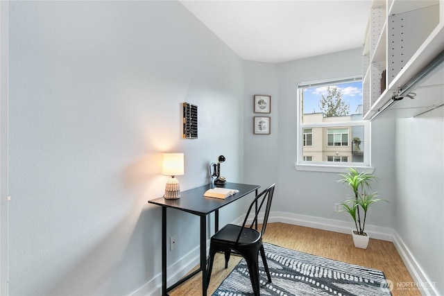 office with light wood-style flooring and baseboards