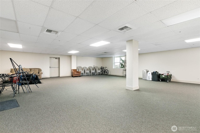 basement with visible vents, carpet floors, baseboards, and a drop ceiling