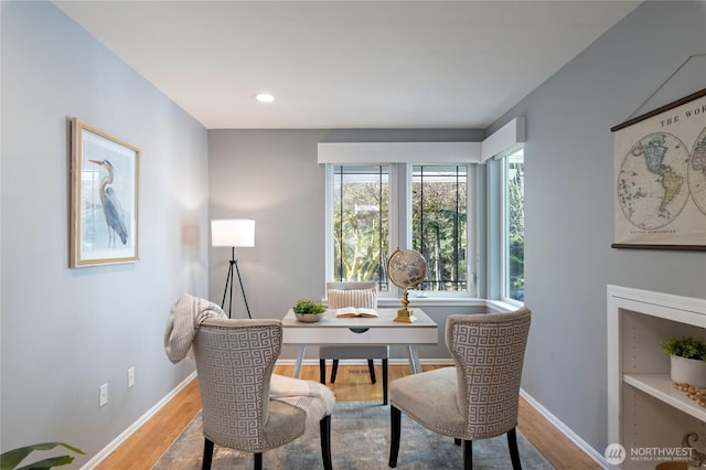 dining room with recessed lighting, wood finished floors, and baseboards