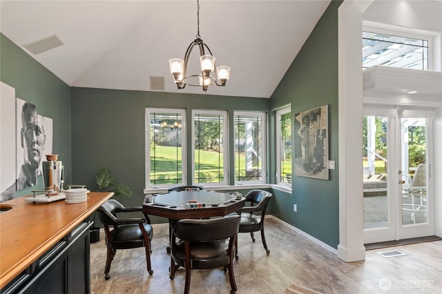 dining space featuring baseboards, a wealth of natural light, visible vents, and an inviting chandelier