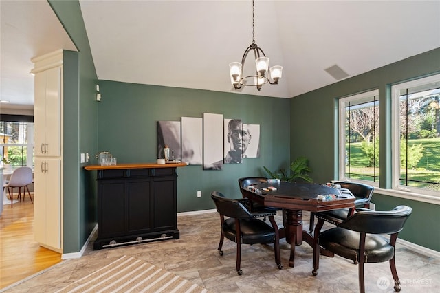 dining space with a chandelier, a wealth of natural light, and visible vents