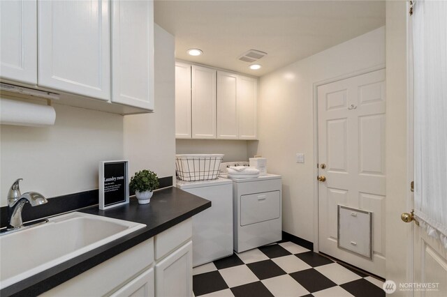 laundry area with light floors, washing machine and clothes dryer, cabinet space, visible vents, and a sink