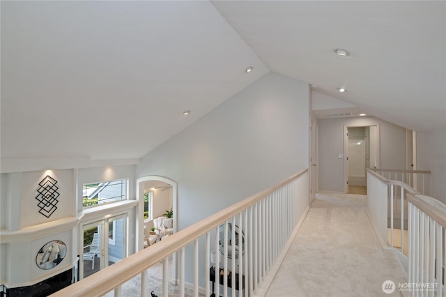 corridor with carpet floors, recessed lighting, vaulted ceiling, and an upstairs landing