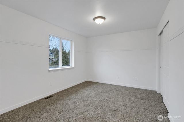 unfurnished bedroom with carpet flooring, visible vents, and baseboards