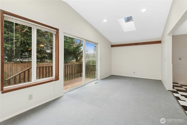 carpeted spare room with vaulted ceiling with skylight, baseboards, and recessed lighting