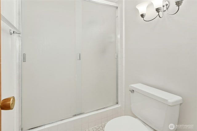 full bathroom featuring a shower stall and toilet