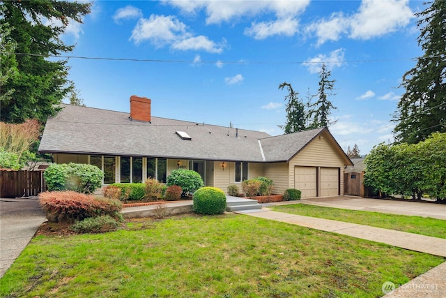 ranch-style home with an attached garage, fence, driveway, a front lawn, and a chimney