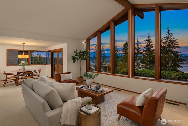 interior space featuring lofted ceiling with beams and visible vents