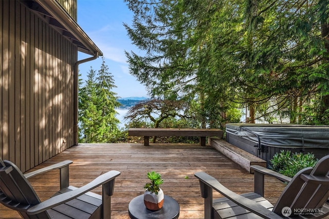 wooden terrace with a covered hot tub