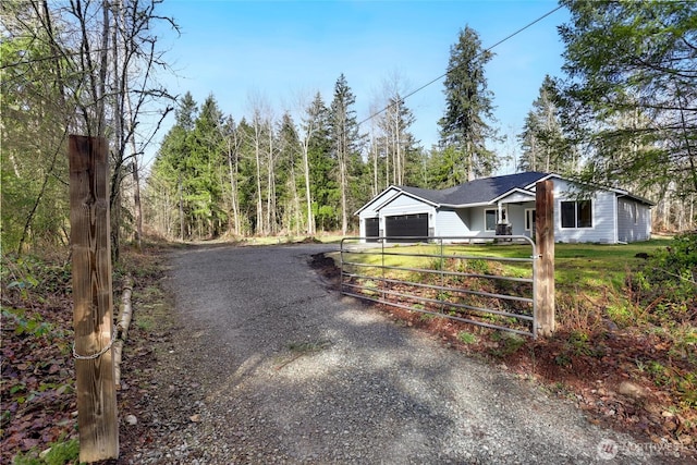 view of road with driveway and a gated entry