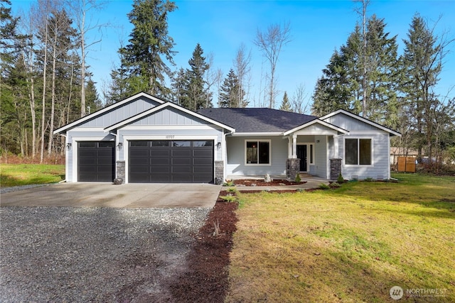 10707 212th St E, Graham, WA 98338 - view of front facade with a front yard, driveway, an attached garage, stone siding, and board and batten siding