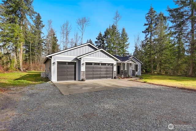 view of front facade featuring board and batten siding, concrete driveway, a front yard, ac unit, and a garage