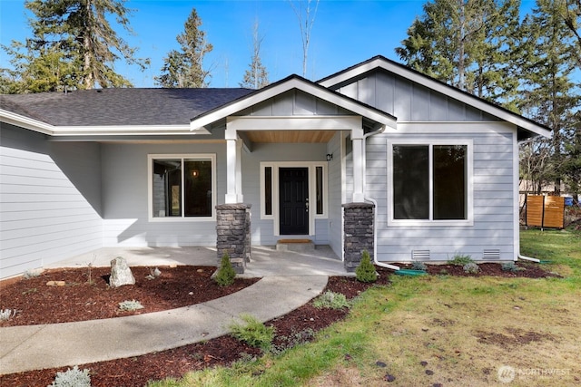 10707 212th St E, Graham, WA 98338 - view of front of home with a front yard, board and batten siding, roof with shingles, and crawl space