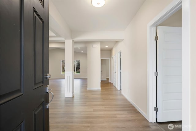 10707 212th St E, Graham, WA 98338 - entryway featuring light wood-style flooring, decorative columns, recessed lighting, and baseboards