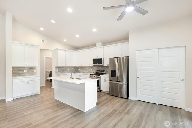 10707 212th St E, Graham, WA 98338 - kitchen with visible vents, light countertops, vaulted ceiling, appliances with stainless steel finishes, and a sink