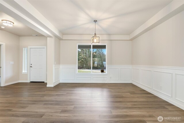 10707 212th St E, Graham, WA 98338 - unfurnished dining area featuring a decorative wall and wood finished floors
