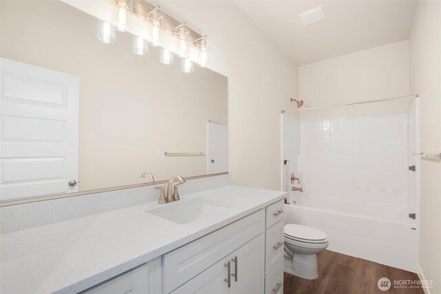 10707 212th St E, Graham, WA 98338 - bathroom with vanity, washtub / shower combination, toilet, and wood finished floors