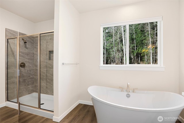 10707 212th St E, Graham, WA 98338 - full bath featuring wood finished floors, a healthy amount of sunlight, and a stall shower