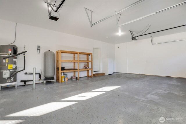 10707 212th St E, Graham, WA 98338 - garage with a garage door opener and water heater