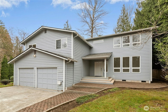 traditional-style home with crawl space, an attached garage, and concrete driveway