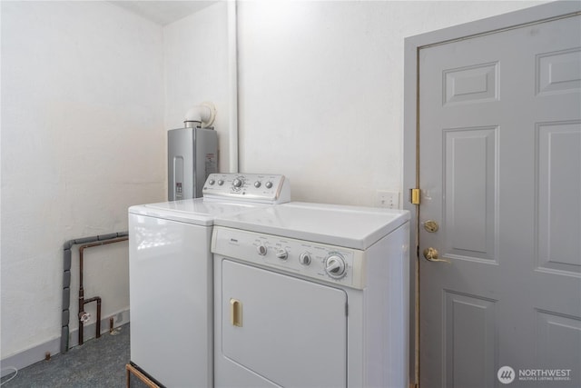 clothes washing area with water heater, laundry area, and washer and clothes dryer