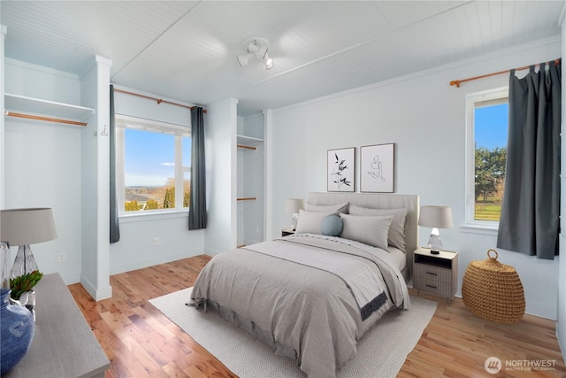 bedroom with light wood-style flooring and baseboards