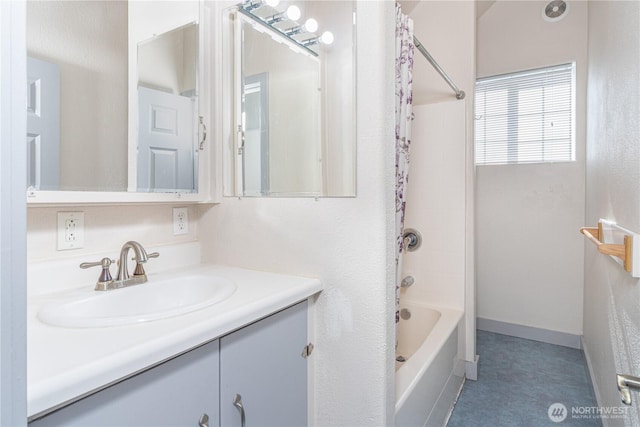 bathroom with shower / bath combination with curtain, vanity, and baseboards