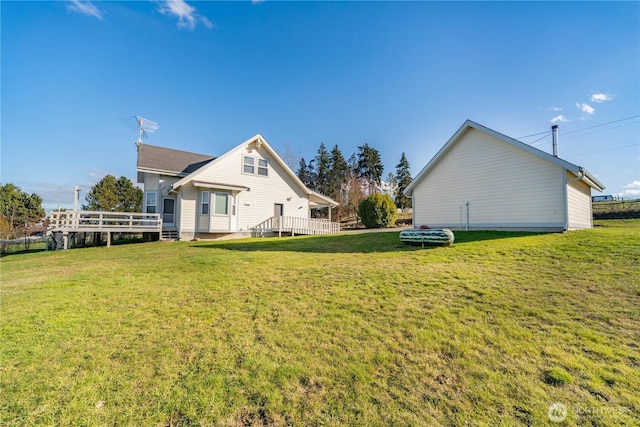 view of side of property featuring a deck and a lawn