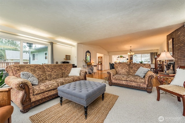 living area with lofted ceiling, a notable chandelier, and a textured ceiling