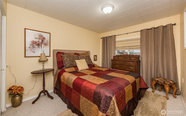 bedroom with carpet floors and baseboards