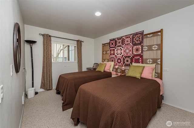 bedroom featuring baseboards and light colored carpet