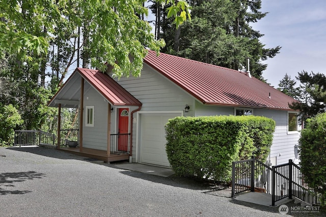 view of front of property with a standing seam roof, metal roof, and an attached garage