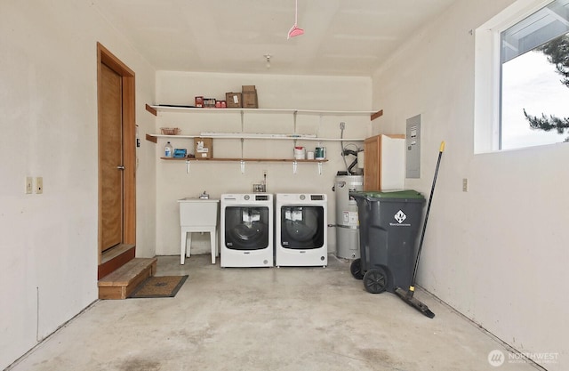 washroom with laundry area, secured water heater, a sink, and separate washer and dryer