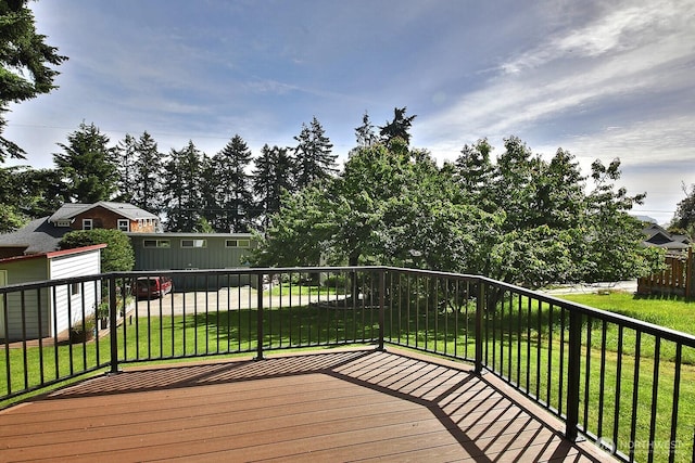 wooden terrace featuring a lawn