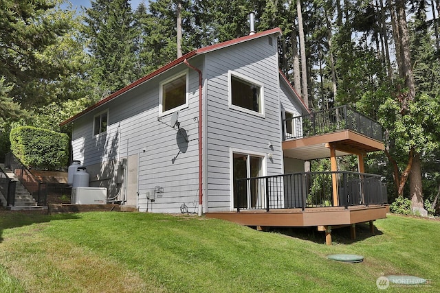 back of house with a lawn and a deck